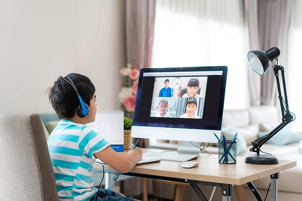 child on a video call with peers