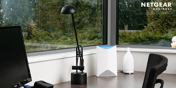 Desk with a monitor, lamp, and router