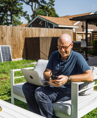 man using wifi in garden with wifi booster